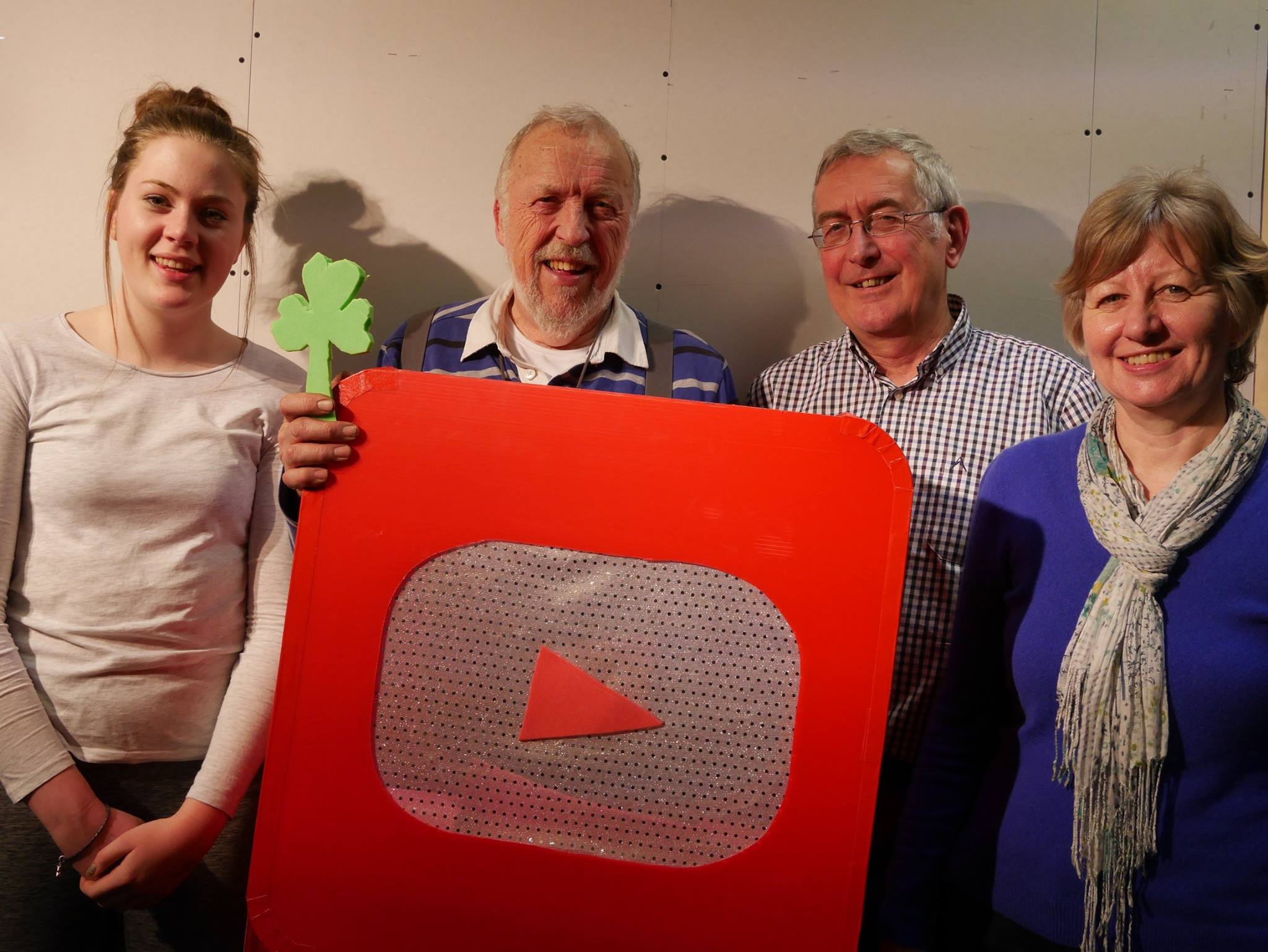 Open book of sheet music on top of piano in an empty music room.